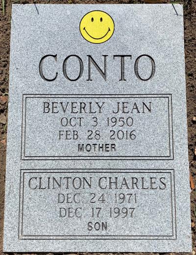 gray granite headstone with classic smiley face emblem